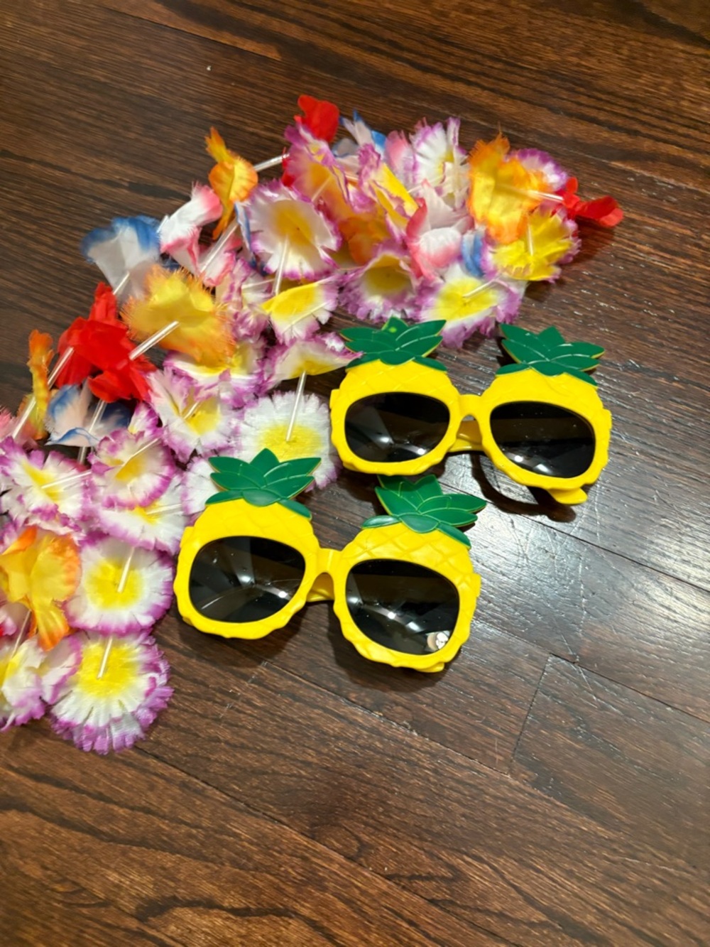 2 pairs of Hawaiian sunglasses and 2 plastic flower necklaces